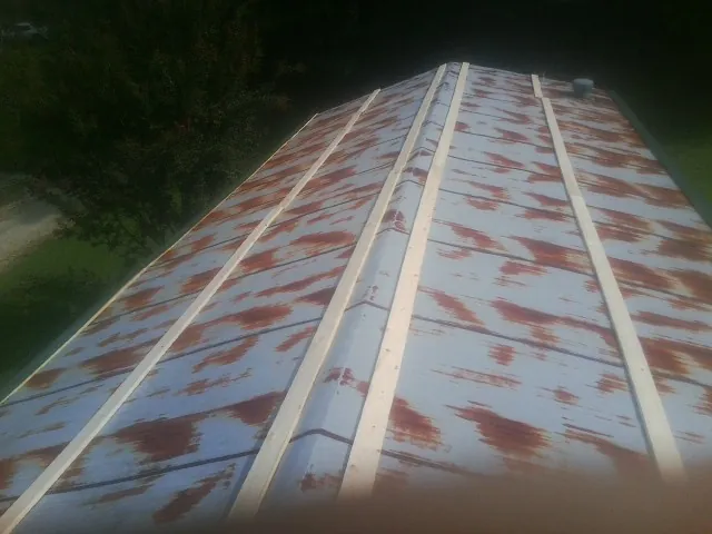 Rusted metal roof panels with new wood purlins before replacement — Storm Damage Roof Repair in Greenland by Roofing Brothers